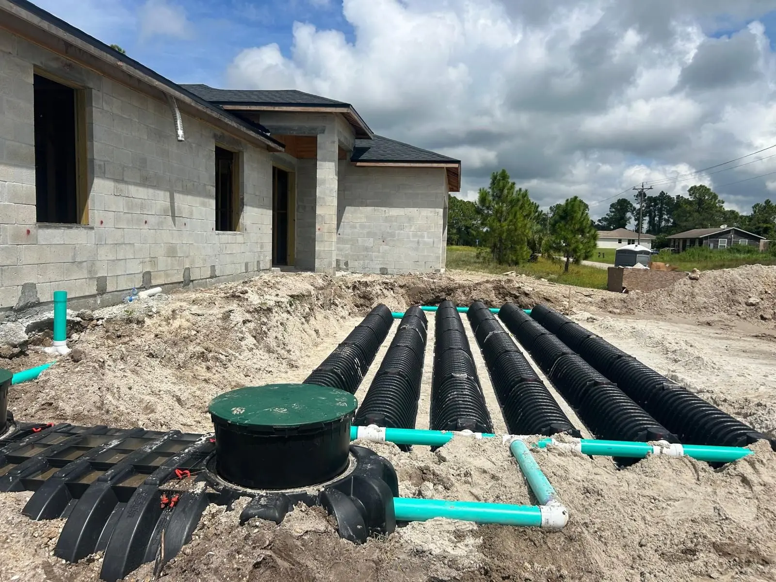 Septic tank riser and drain field chambers installed at a new block-construction home in Florida