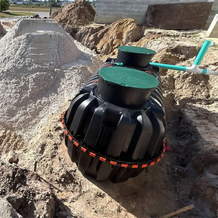 Septic tank set in the excavation during a system installation in Cape Coral, Florida, with the access risers in place.