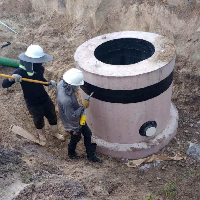 Crew setting a precast concrete structure on an underground utility job in Kissimmee, Florida.